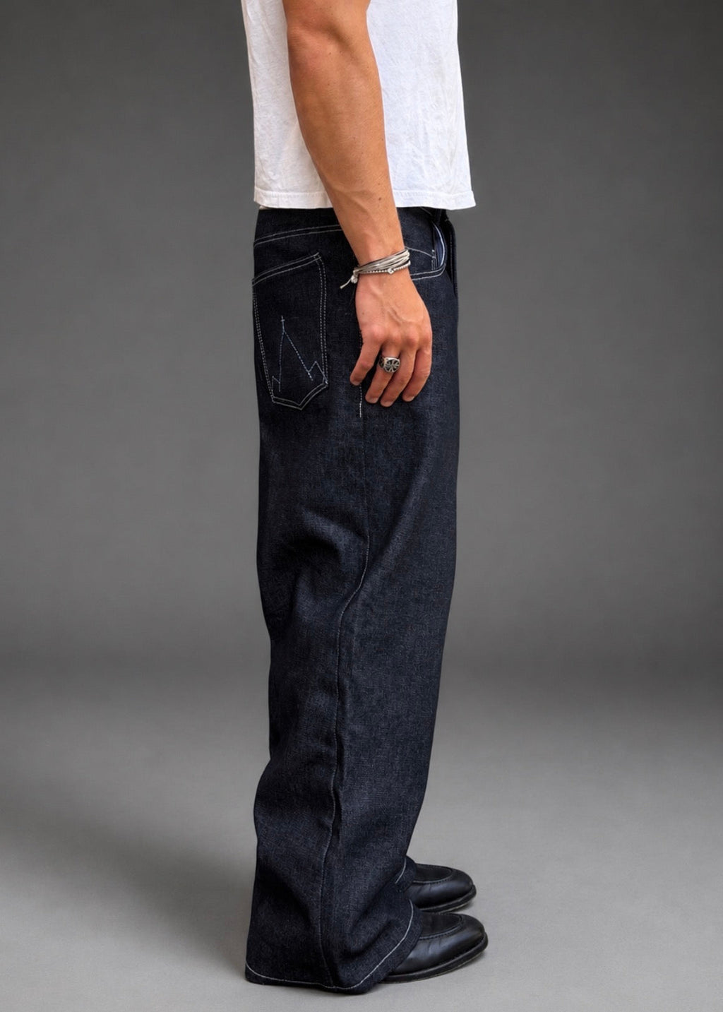 Divine 144 baggy raw indigo denim jeans with wide straight-leg fit and mountain embroidery on the back pocket